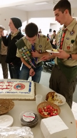 Justin cutting cake for others at his ceremony since he cannot eat it due to his Celiac disease.