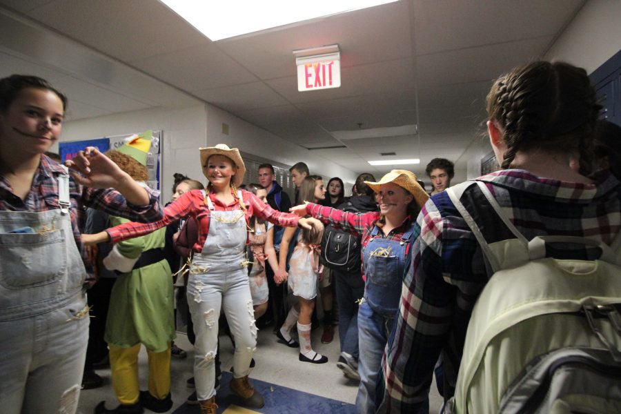 Often during senior Halloween, groups that dress as an ensemble perform during passing time between classes, as these farmer/scarecrow students did on Monday.