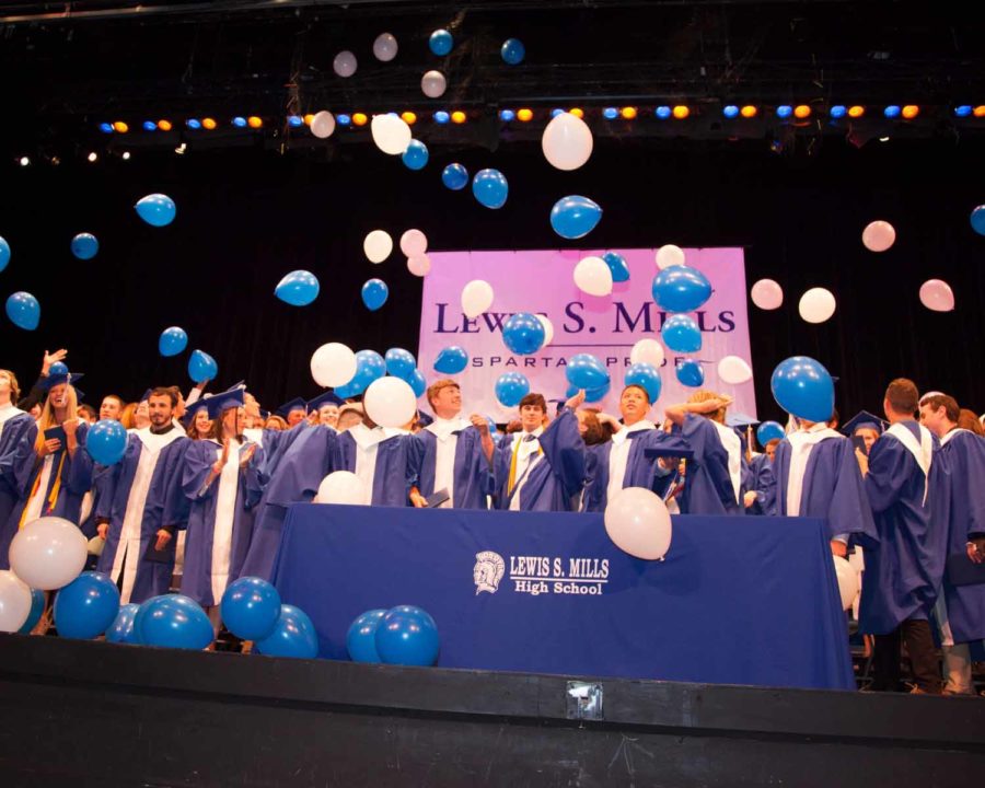 Students at the 2016 graduation wore blue gowns, marking the second or third year of a more gender-neutral approach to graduation garb at Mills. School officials and students revisited graduation gown colors this spring before deciding to maintain the all-blue gowns for seniors this June.