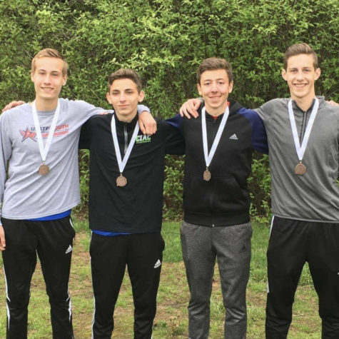 Senior Nick OBrien, second from right, poses with members of the Mills 4X800 relay team. Contributed photo
