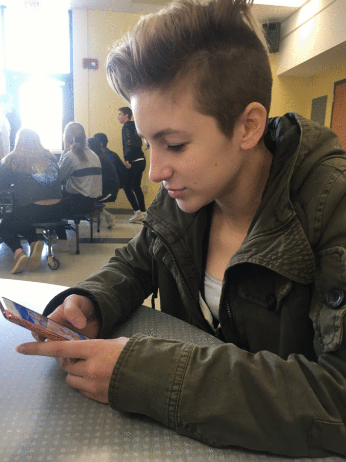Sophomore Amber Laskos checks something on her phone during lunch one recent December day. On select Fridays throughout the year, students are encouraged to stow their phones.