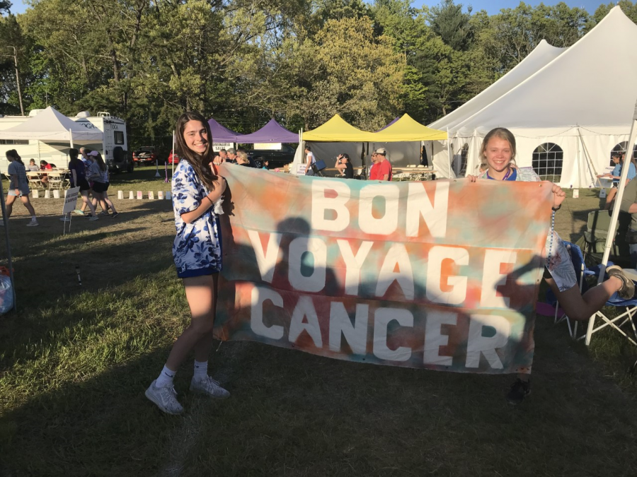 Lauren Alvarez and Morgan Sokol, members of a Relay for Life team of Lewis S. Mills students, hold a banner at last years event in Farmington.