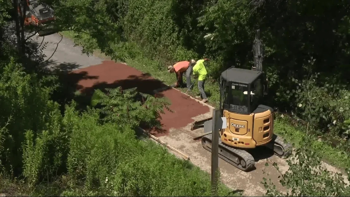 Crews test a new trail surface beneath the West High Street Bridge on the Ghost Town Trail in Ebensburg