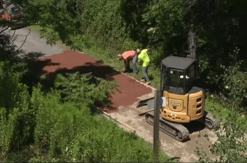 Crews test a new trail surface beneath the West High Street Bridge on the Ghost Town Trail in Ebensburg