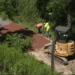 Crews test a new trail surface beneath the West High Street Bridge on the Ghost Town Trail in Ebensburg