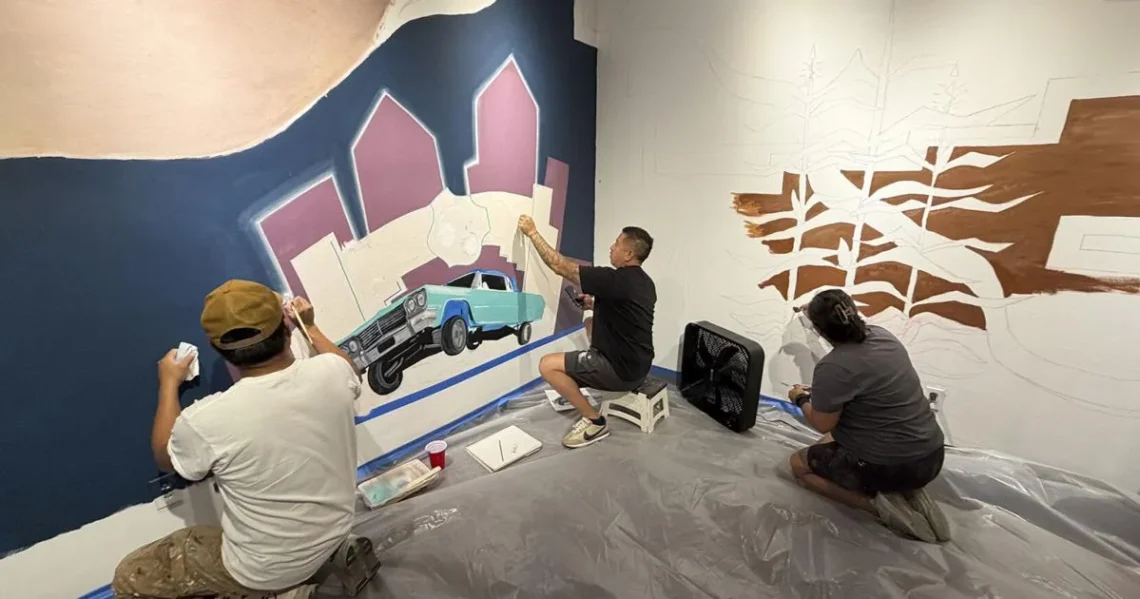 Artists working on The Old Road mural at the Indian Pueblo Cultural Center