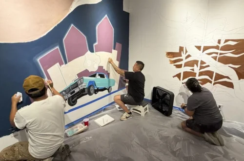 Artists working on The Old Road mural at the Indian Pueblo Cultural Center