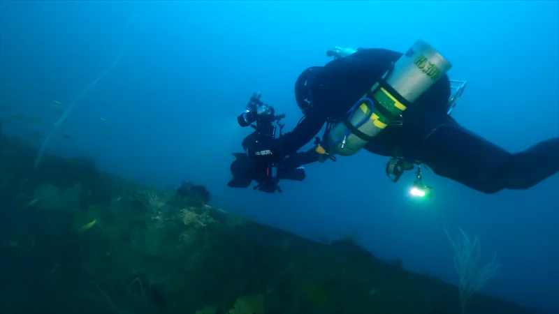Underwater wreck of the Hōfuku Maru covered in silt off the coast of the Philippines